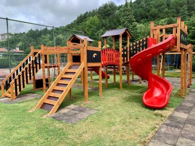 Wooden playground with red slides — Elysee